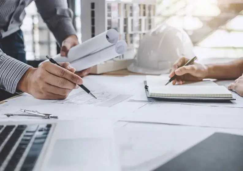 engineering team reviewing blueprints