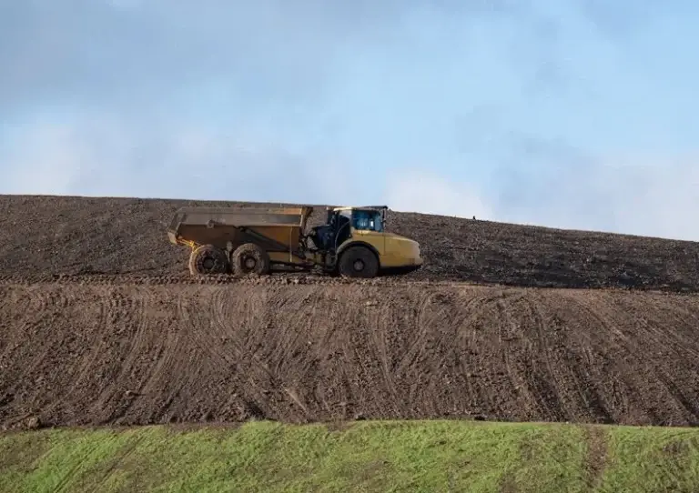 heavy equipment digging out landfill