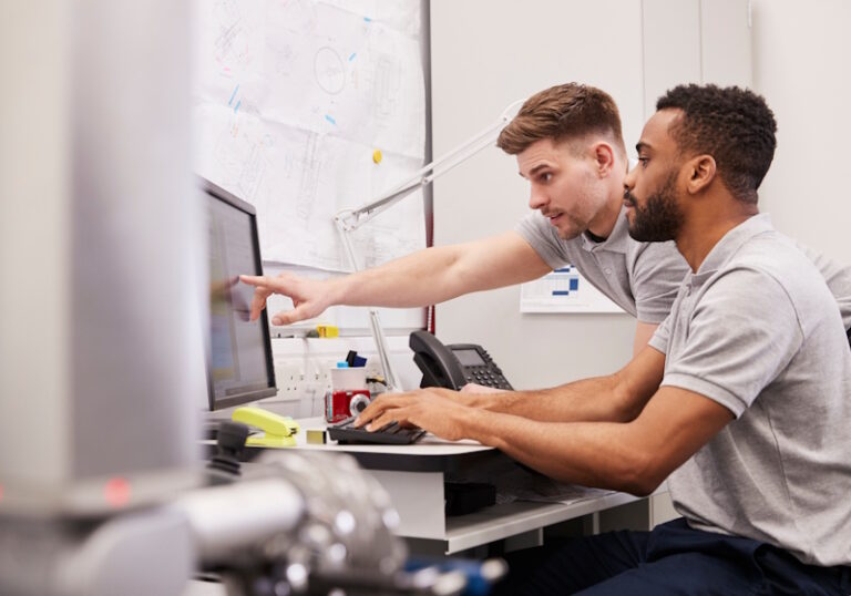 engineers reviewing plans on computer