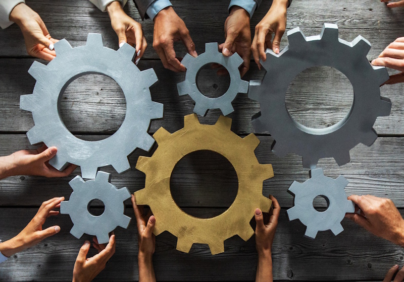 hands holding gears together