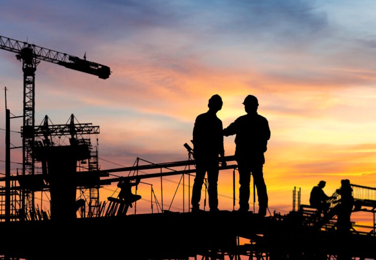 people talking at a construction site at dusk